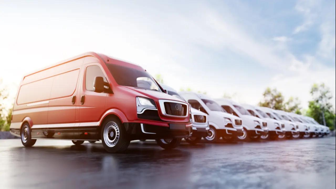 A line of business vans parked together at sunset